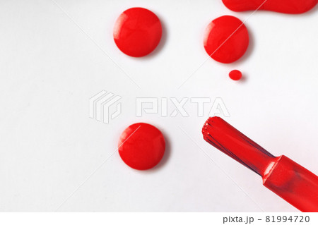 Drops of spilled nail polish over white background 81994720