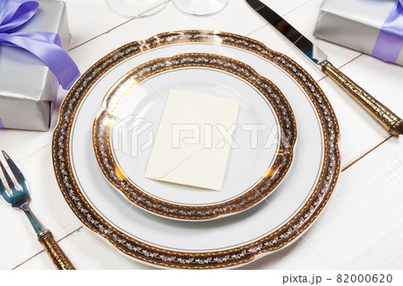 Holiday table setting on wooden table in lilac colors 82000620