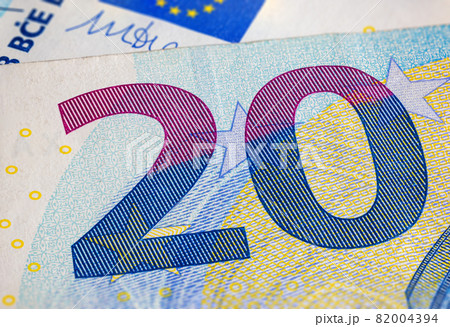 Twenty Euro banknote fragment macro. Closeup photo of a part of the new twenty euro note. Money of the European Union. Europe currency. Intaglio printed denomination. Detailed concept euro design. Twenty Euro banknote fragment macro. Closeup photo of a part of the new twenty euro note. Money of the European Union. Europe currency. Intaglio printed denomination. Detailed concept euro design. 82004394