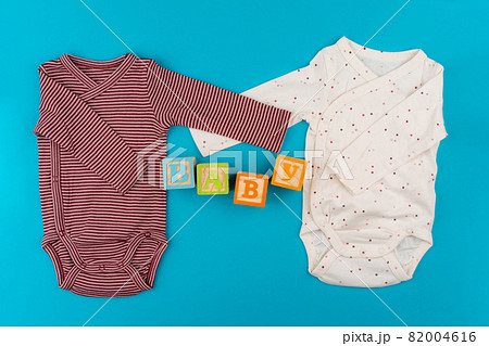 baby clothes on blue background top view 82004616