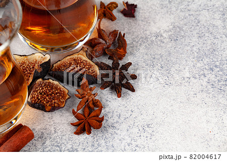 Cup of tea decorated with pieces of dried orange and fig 82004617