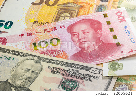 Close up to hundred Yuan of the People Republic of China laying between 50 US Dollar and 50 Euro banknotes. 100 Renminbi banknotes. Trade war. Money of the US and Europe with Chinese currency Close up to hundred Yuan of the People Republic of China laying between 50 US Dollar and 50 Euro banknotes. 100 Renminbi banknotes. Trade war. Money of the US and Europe with Chinese currency 82005621