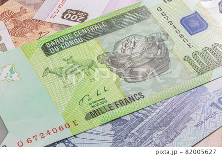 Close up to five thousand Francs of the Republic of Congo. Paper banknotes of the African country. Detailed capture of the front art design. Detailed money background wallpaper. Currency bank note Close up to five thousand Francs of the Republic of Congo. Paper banknotes of the African country. Detailed capture of the front art design. Detailed money background wallpaper. Currency bank note 82005627