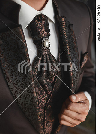 Luxurious modern expensive brown wedding men's suit with an abstract pattern and pearls on a tie with a white shirt 82006365