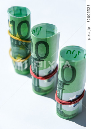 Close up of Euro money roll. Euro banknote set cash money - EU currency. Rolled with rubber euro notes. Banknotes stacked on each other in different positions 82006523