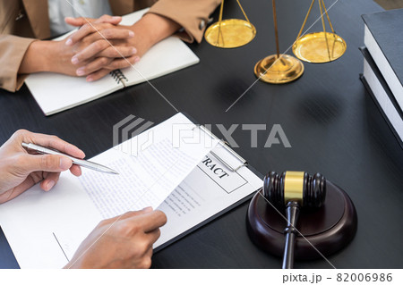 lawyer or judge meeting with client consulting help discussing contract paper agreement. 82006986