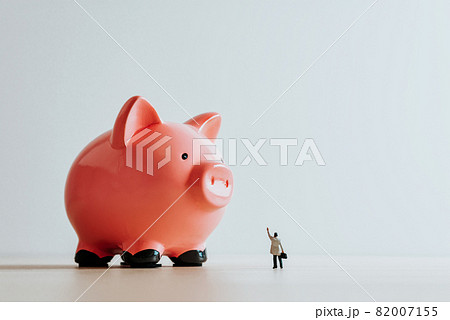 Lonely businessman and Piggy Bank. Business concept Lonely businessman and Piggy Bank. Business concept 82007155