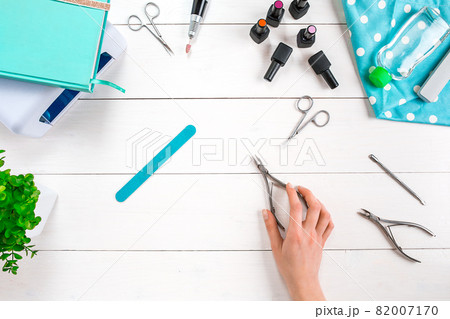 Manicure set and nail polish on wooden background 82007170