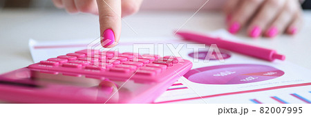 Female hands work calculator near pen and business charts Female hands work calculator near pen and business charts 82007995