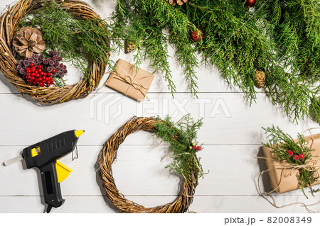 How to make christmas door wreath. The working process. The decorator's workplace. Top view How to make christmas door wreath. The working process. The decorator's workplace. Top view 82008349