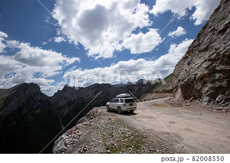 Driving off road car on high altitude mountain cliff edge Driving off road car on high altitude mountain cliff edge 82008550
