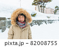 Cute asian boy in snow 82008755