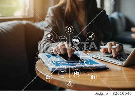 Businesswoman working with smartphone to calculate the numbers of static in office. Finance accounting concept. Businesswoman working with smartphone to calculate the numbers of static in office. Finance accounting concept. 82010040