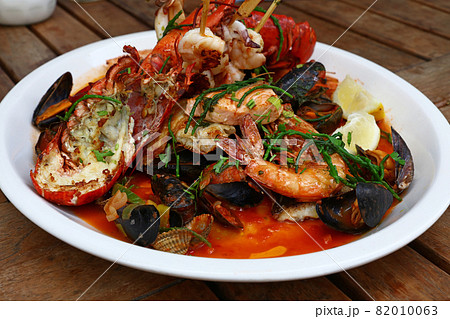 Grilled seafood platter on wooden table 82010063
