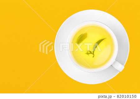Cup of green oolong tea over yellow 82010150