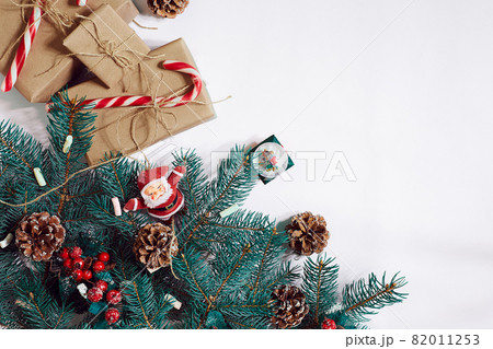 Christmas or New Year background: fur-tree, branches, gifts, decoration on a white background Christmas or New Year background: fur-tree, branches, gifts, decoration on a white background 82011253