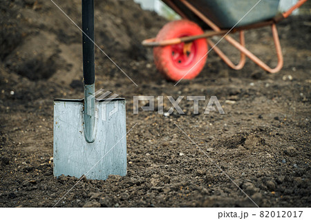 Working with garden tools, shovel and wheelbarrow on the site of a country house. Preparation for construction work. Working with garden tools, shovel and wheelbarrow on the site of a country house. Preparation for construction work. 82012017