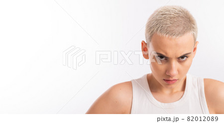Displeased young caucasian woman with short haircut on white background. 82012089