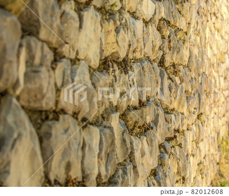 Stone fence or wall. Close up. Selective focus Stone fence or wall. Close up. Selective focus 82012608