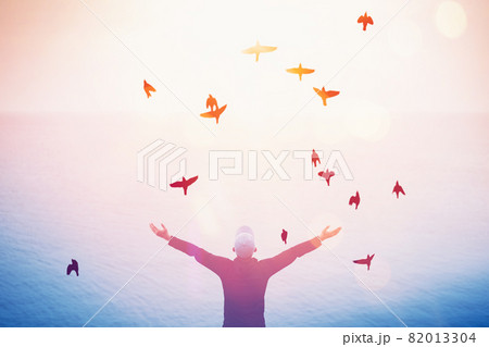 Copy space of man rise hand up on sunset sky at beach and island background. 82013304