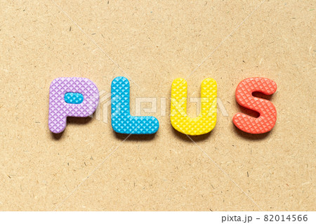 Foam alphabet letter in word plus on wood background 82014566