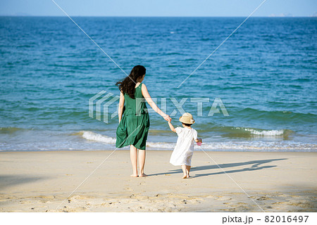 Mother and daughter having fun on the beach Mother and daughter having fun on the beach 82016497