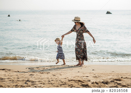 Mother and daughter having fun on the beach Mother and daughter having fun on the beach 82016508
