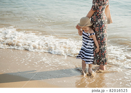 Mother and daughter having fun on the beach Mother and daughter having fun on the beach 82016525
