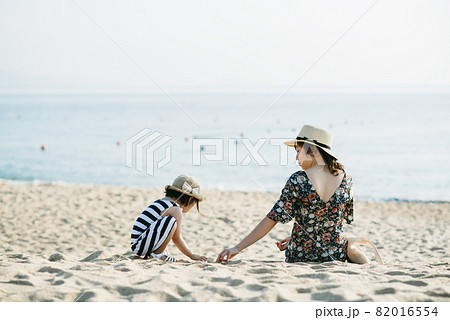 Mother and daughter having fun on the beach Mother and daughter having fun on the beach 82016554