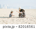 Mother and daughter having fun on the beach 82016561
