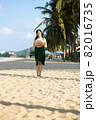 Young woman on sandy beach 82016735