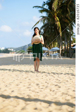 Young woman on sandy beach 82016735