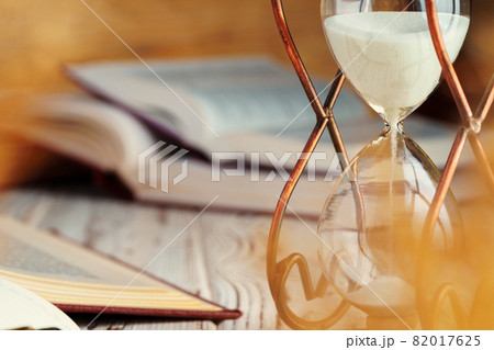 Hourglass with sand close up on wooden background 82017625