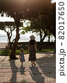 Mother taking her daughter to play in the park 82017650