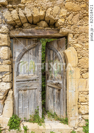 Old and ruinous door in a old greek village during daytime Old and ruinous door in a old greek village during daytime 82018421