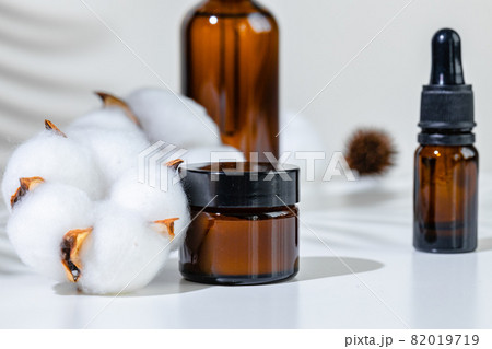 Skincare products containers on a white background with creative shadows 82019719