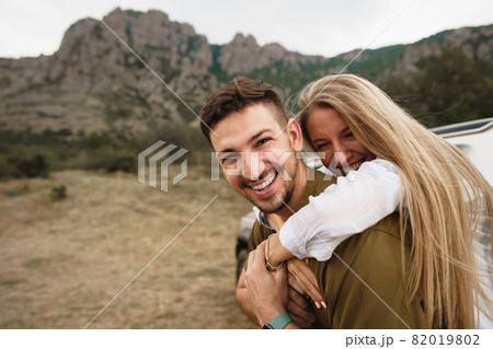 Happy loving couple hiking and hugging in mountains 82019802