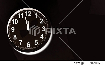 Black clock face of a wall clock show the time. It's close to 12 o'clock. The latest report of the atomic scientist shows the doomsday clock 100 seconds to twelve.  Time is running out for mankind. 82020073