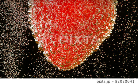 Super slow motion of strawberry falling into champagne 82020641