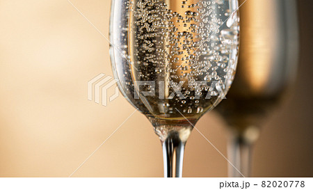 Champagne bubbles in glass flutes. 82020778