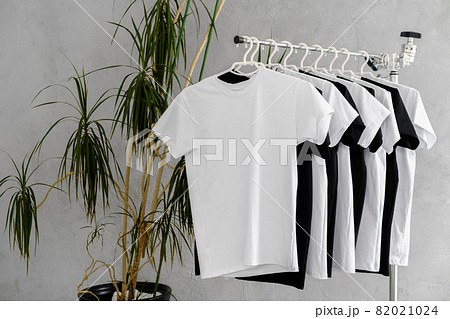 Row of black and white t-shirts hanging on rack Row of black and white t-shirts hanging on rack 82021024