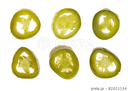 Pickled jalapeno pepper, isolated on white background. Slices of preserved hot serrano. Close up. Top view. 82021134