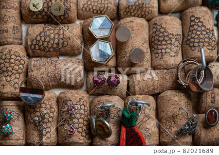 Different jewelry is stuck in a stand of wine corks Different jewelry is stuck in a stand of wine corks 82021689