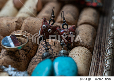 Different jewelry is stuck in a stand of wine corks Different jewelry is stuck in a stand of wine corks 82021690