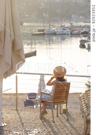 girl tourist stands on the embankment of the sea in the bay of paleokastritsa girl tourist stands on the embankment of the sea in the bay of paleokastritsa 82023952