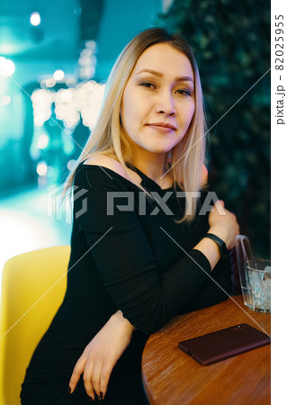 Portrait of beautiful blonde girl in black dress. Portrait of beautiful blonde girl in black dress. 82025955