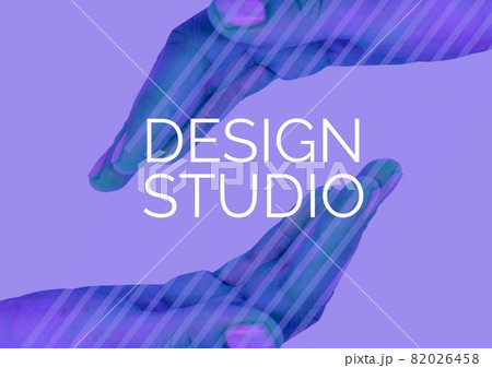 Digitally generated image of design studio text over two hands against purple background 82026458