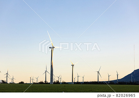 General view of wind turbines in countryside landscape with cloudless sky 82026965