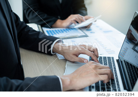 Two business leaders talk about charts, financial graphs showing results are analyzing and calculating planning strategies, business success building processes 82032394