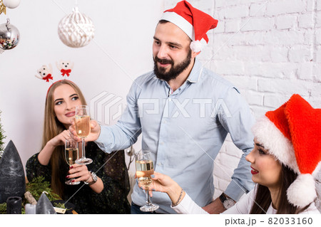Christmas party cheerful friends at having drink and fun 82033160